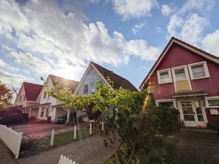 sunrise behind a row of houses